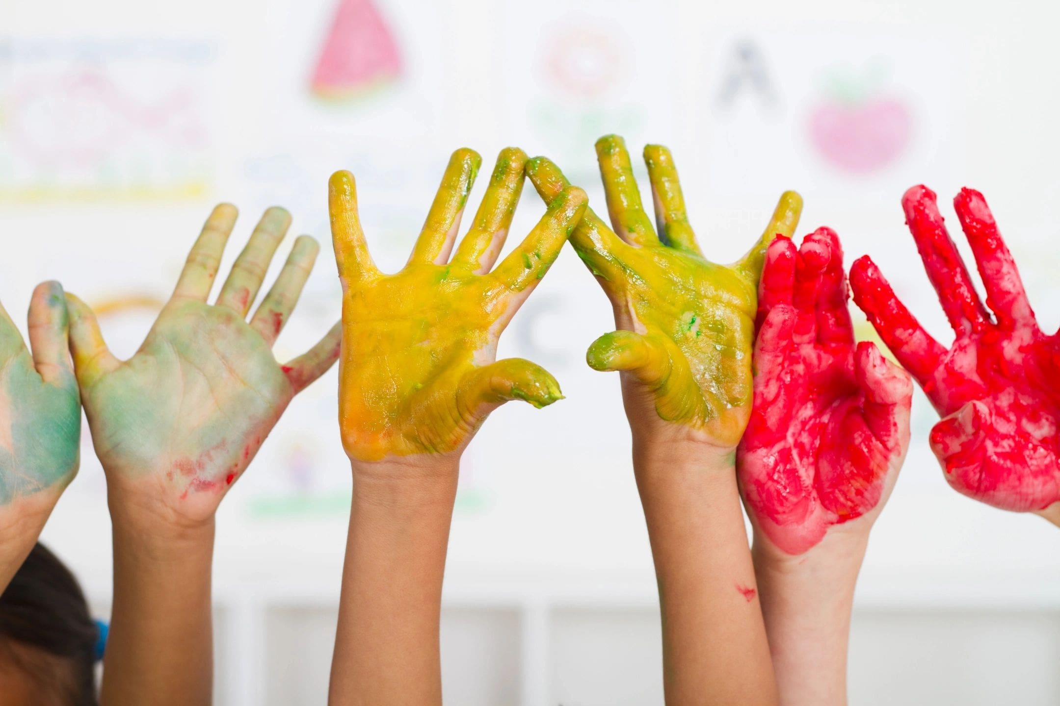 A group of people with their hands painted in different colors.