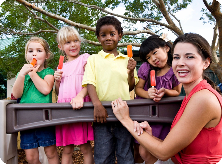 A group of children holding up popsicles in front of a woman.